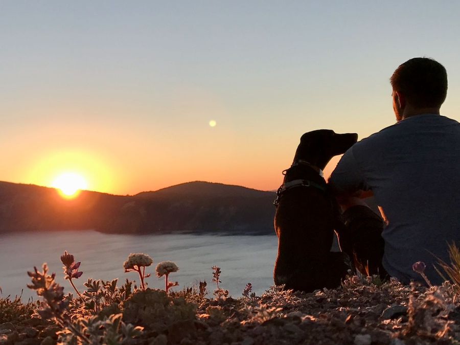 Sitting with my dog on the rim of Crater Lake at sunset